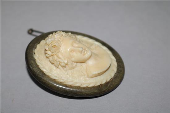 A horn mounted carved ivory cameo brooch, 2in.